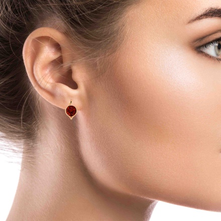 Gold Earrings with a 9mm Statement Garnet on a Model