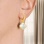 Mother-of-Pearl Quatrefoil Clover Earrings on a Model